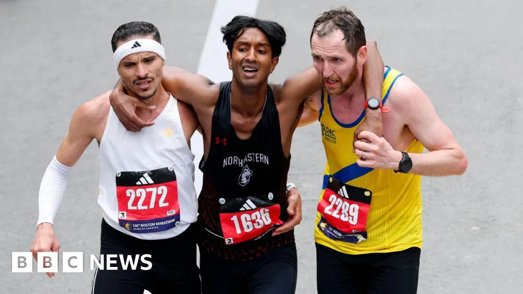 Runners Assist Exhausted Competitor at Boston Marathon Finish Line