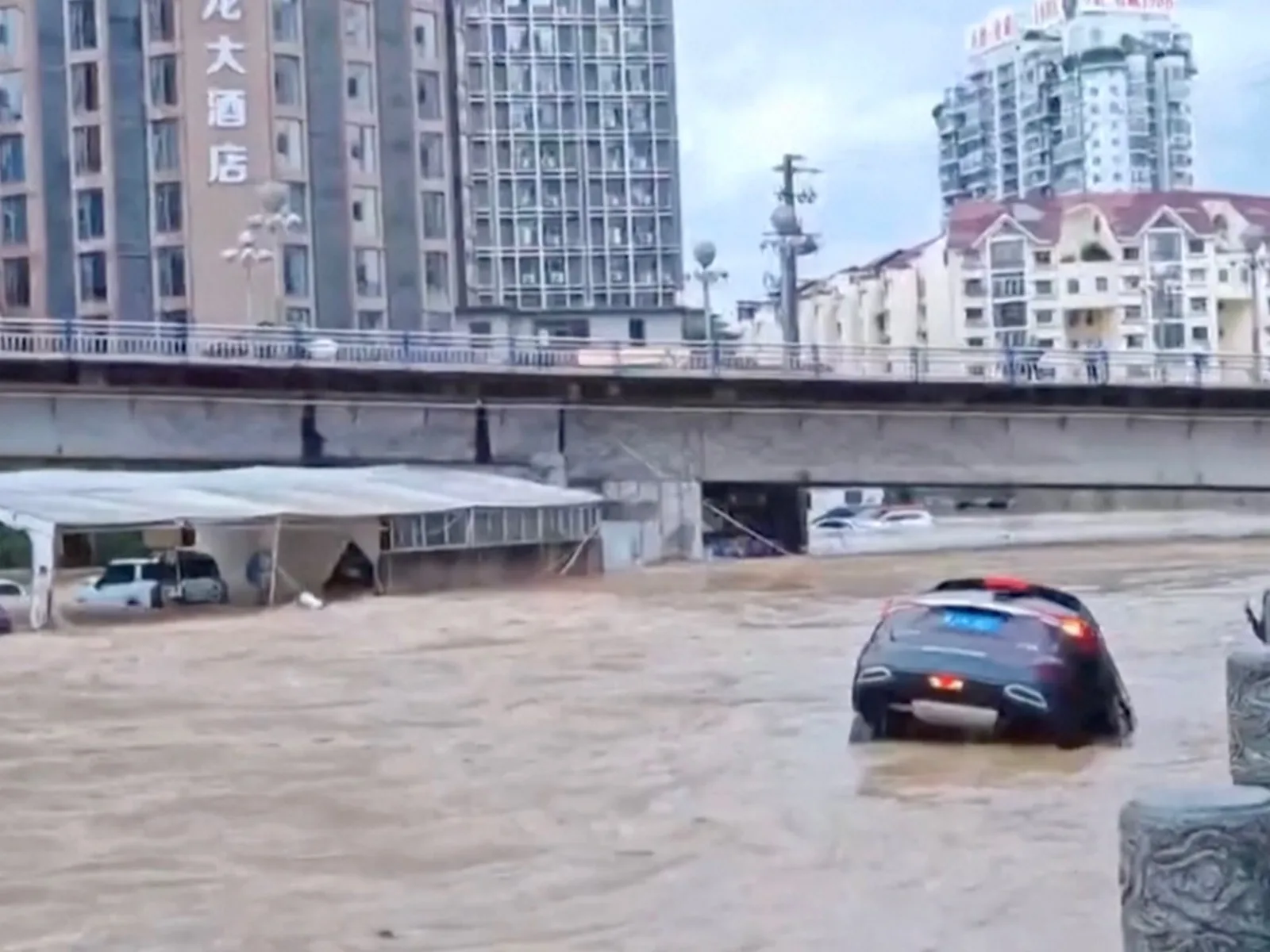Flooding in Southern China Destroys Bridge and Leaves Residents Trapped